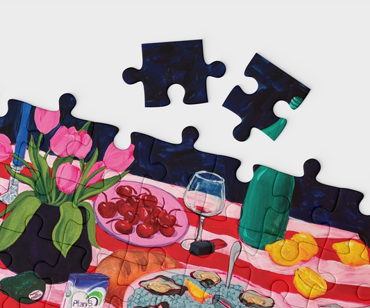 Making Plans jigsaw puzzle with a completed section showing a table setting with food and flowers.
