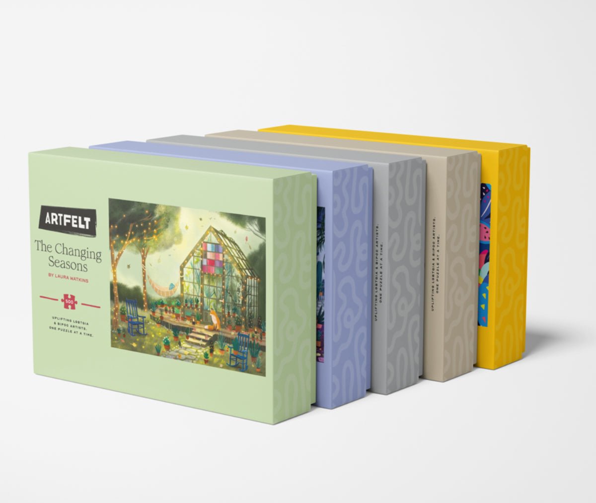 The Changing Seasons Jigsaw Puzzle set with other Artfelt puzzle boxes