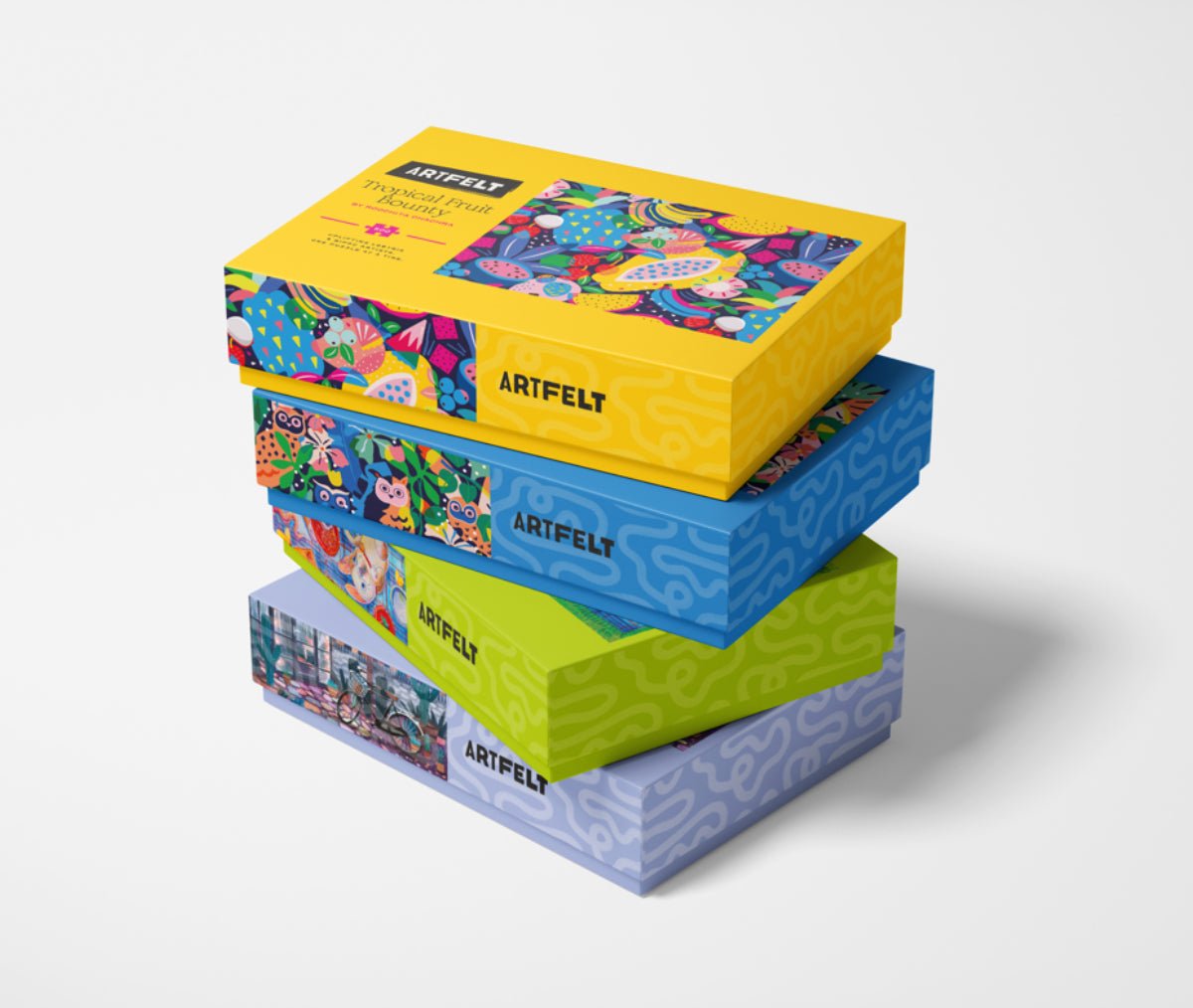 Tropical Fruit Bounty Jigsaw Puzzle stacked with other Artfelt puzzle boxes