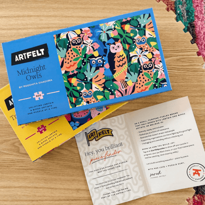 Artfelt Midnight Owls jigsaw puzzle with colorful owl design on a table